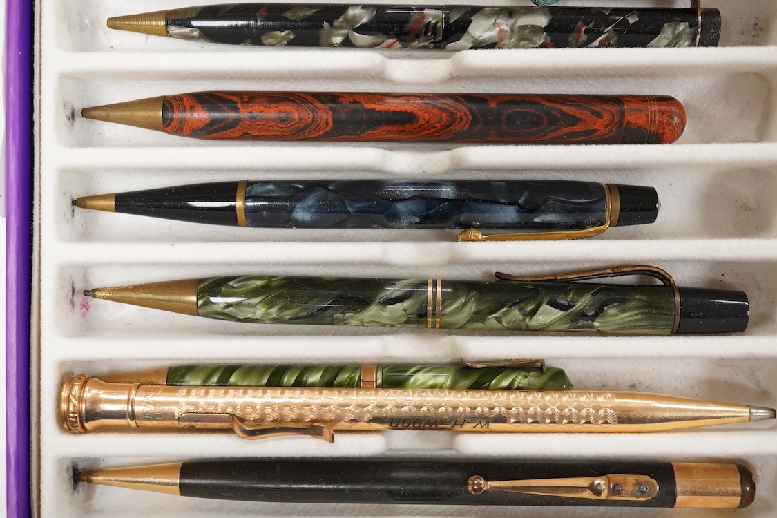 A collection of vintage pencils including an early enamel example